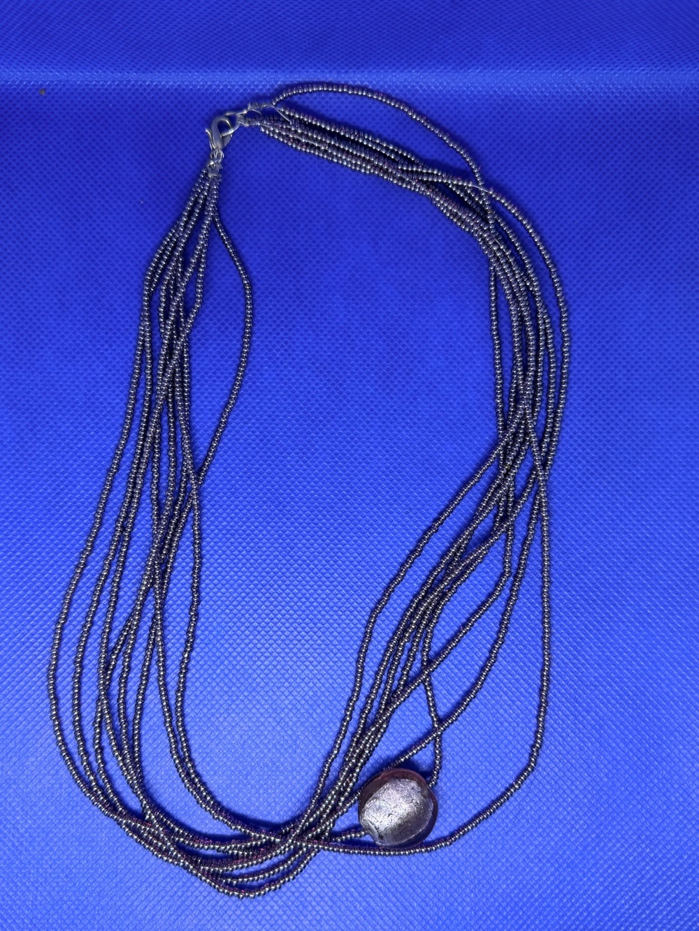 Multi-Strand Dark Metallic Beaded Necklace with Accent Bead